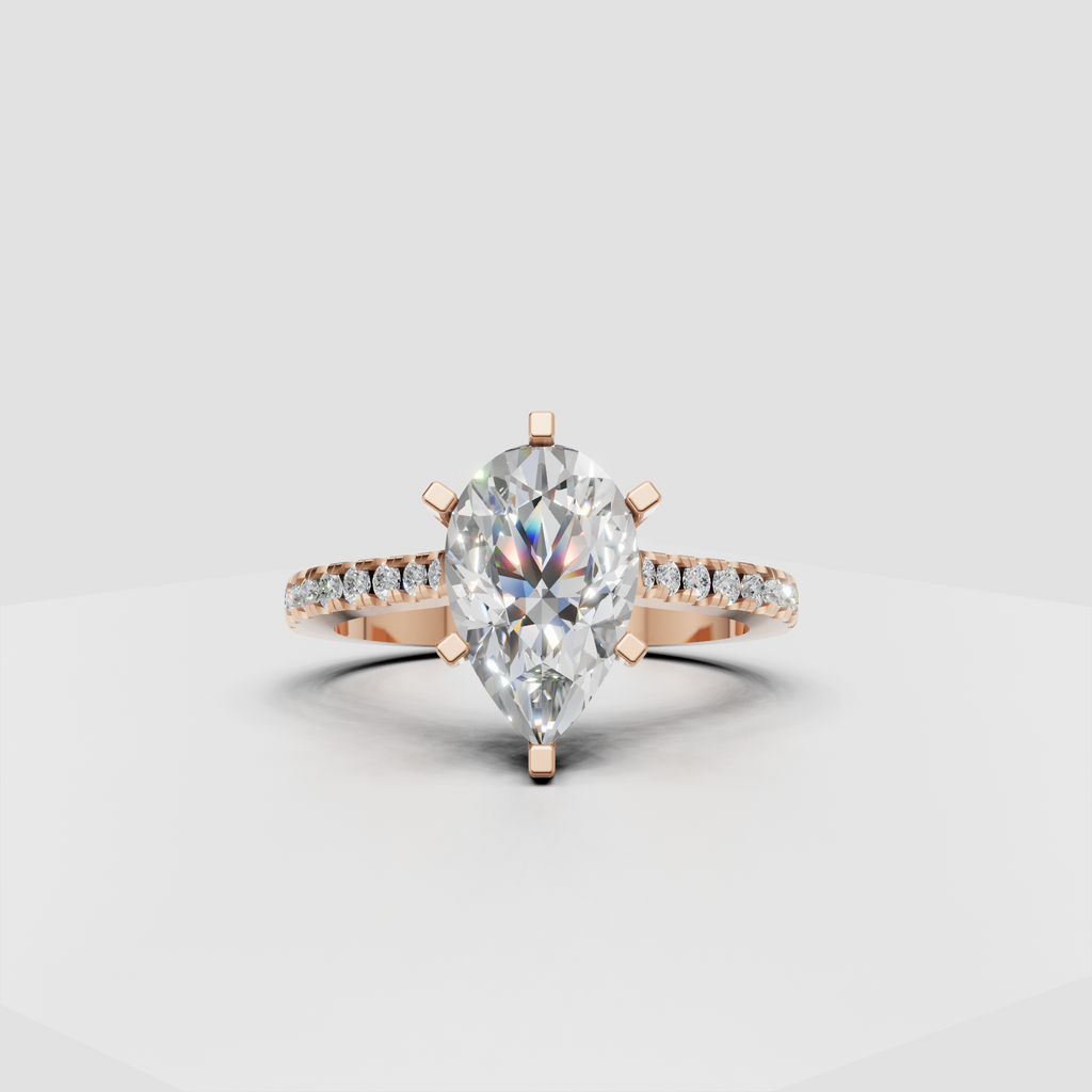 Top view of pear cut diamond engagement ring with six gold prongs