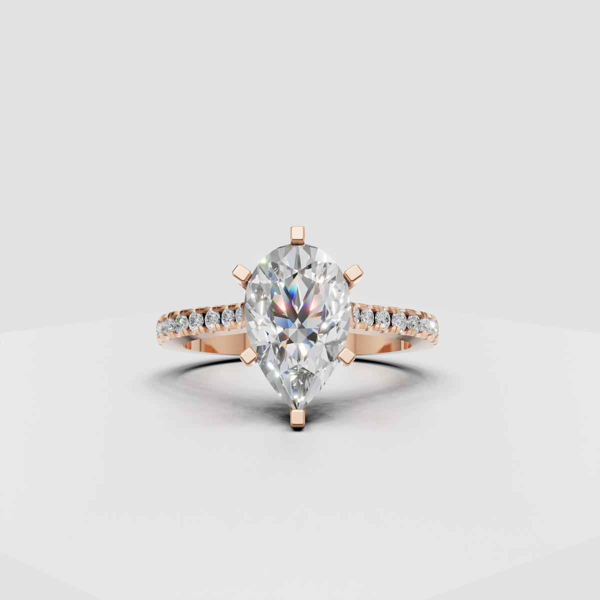 Top view of pear cut diamond engagement ring with six gold prongs