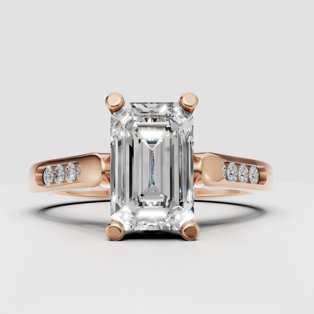 Modern emerald cut diamond engagement ring with architectural shoulders.