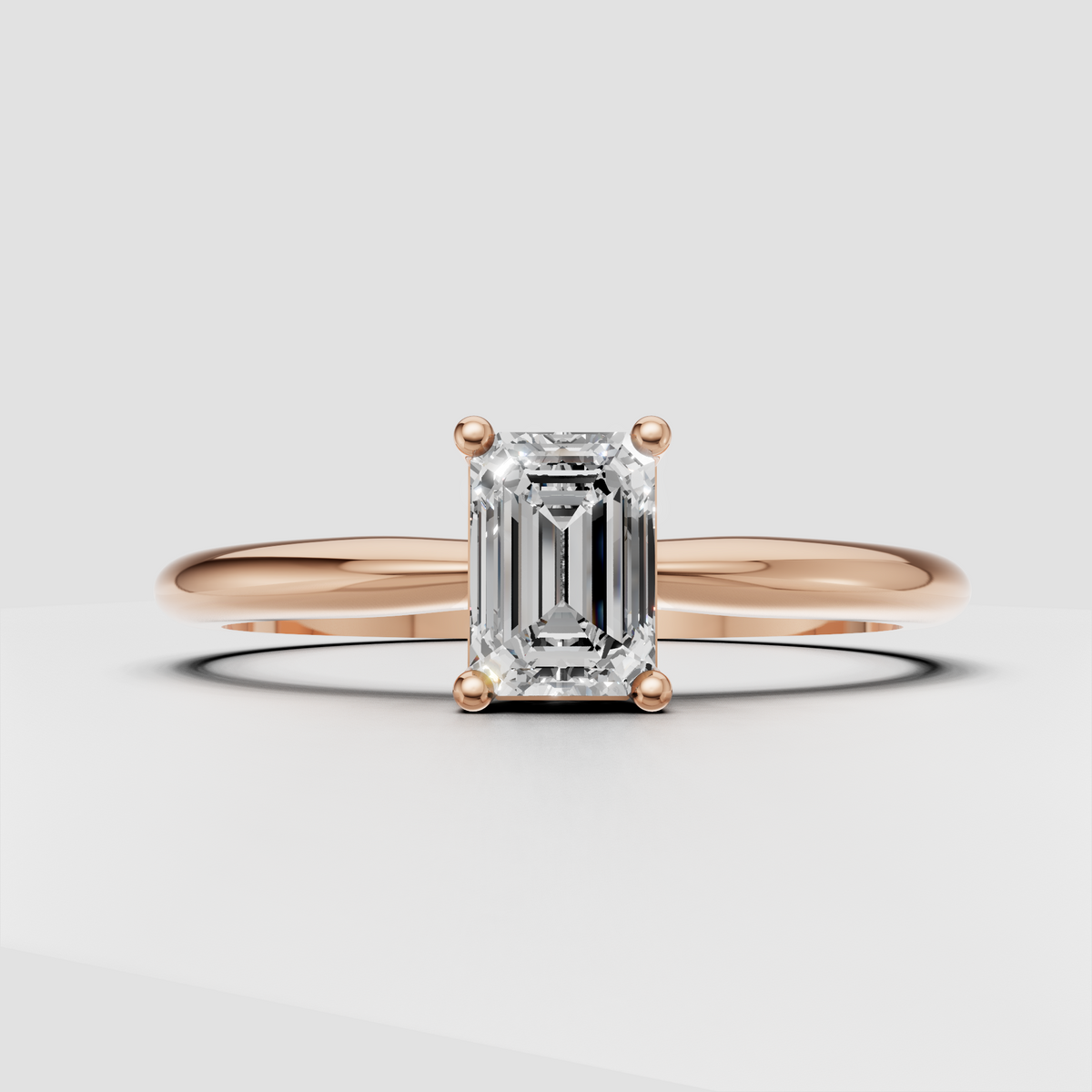 Minimalist emerald cut solitaire engagement ring in gold
