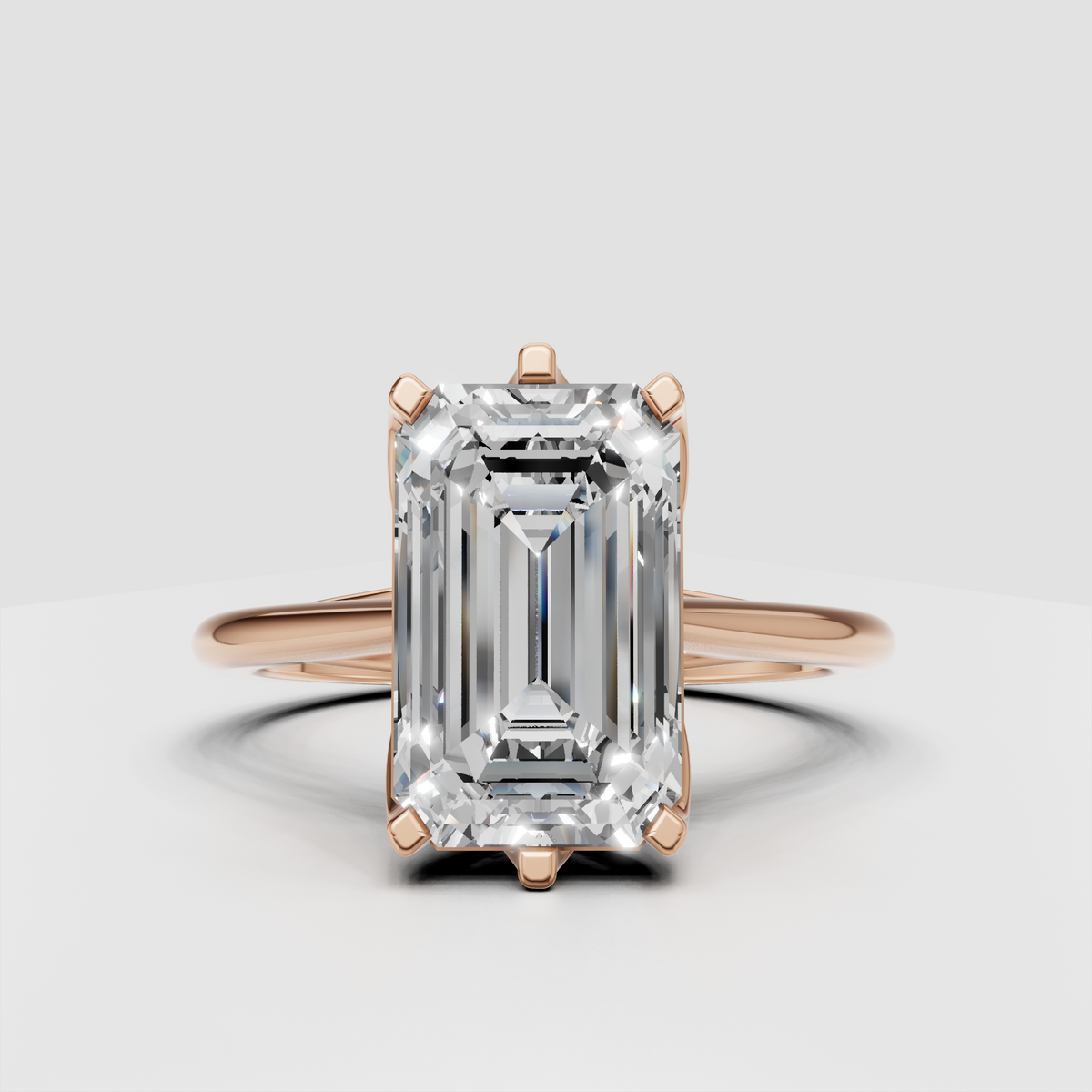 Modern emerald cut solitaire ring with sculptural shoulders