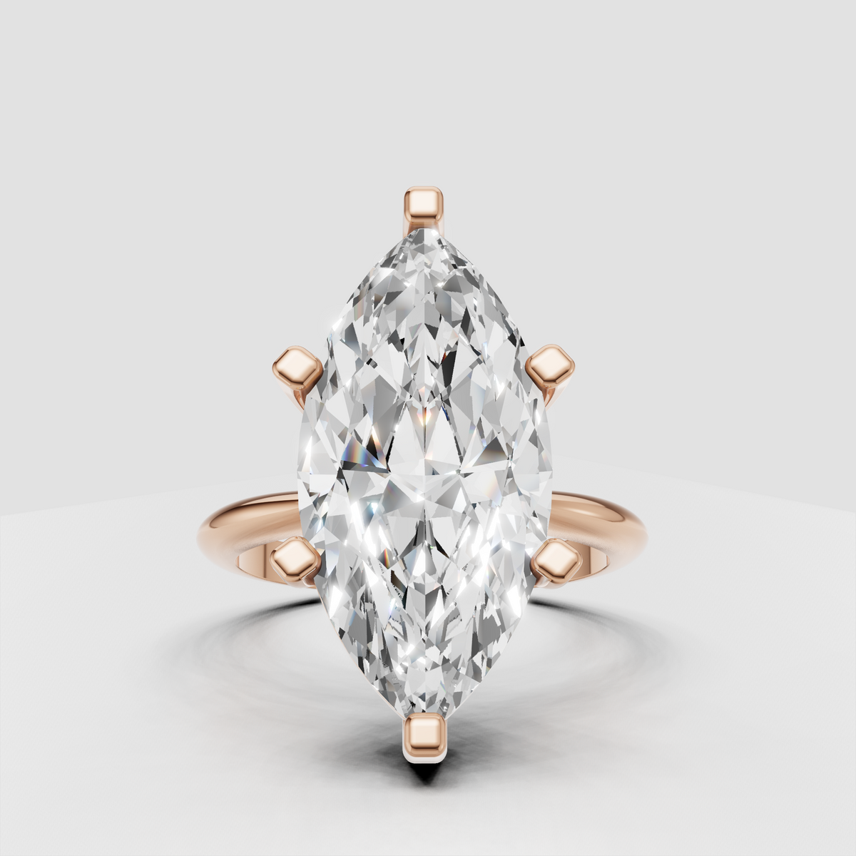 Elongated marquise canter diamond in six-prong gold setting