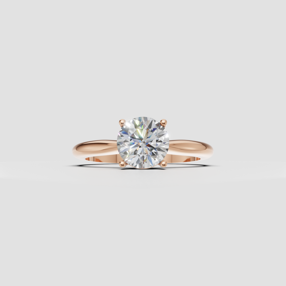 Round cut diamond engagement ring with smooth tapered yellow gold band