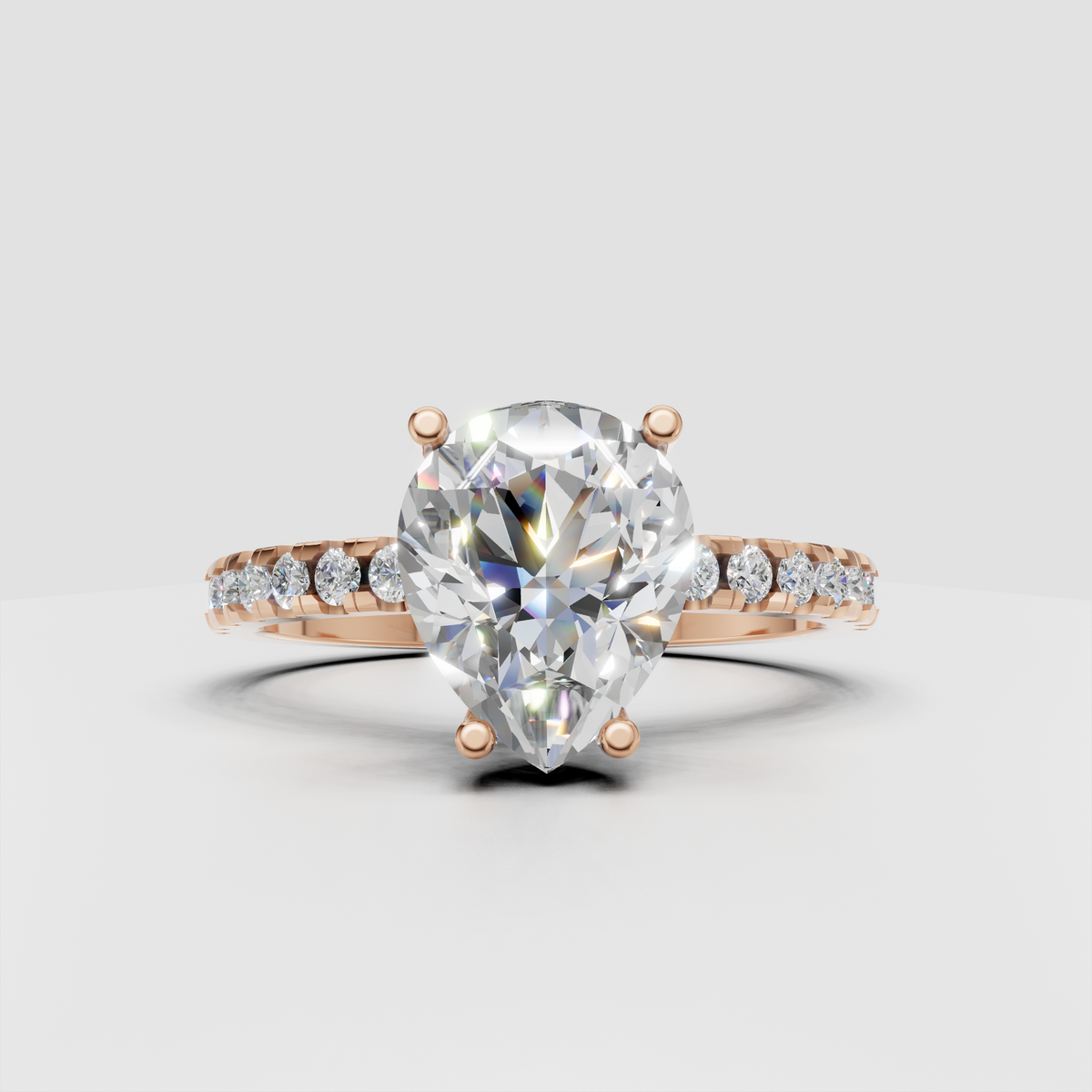 Pear diamond ring with polished gold band and pavé detailing