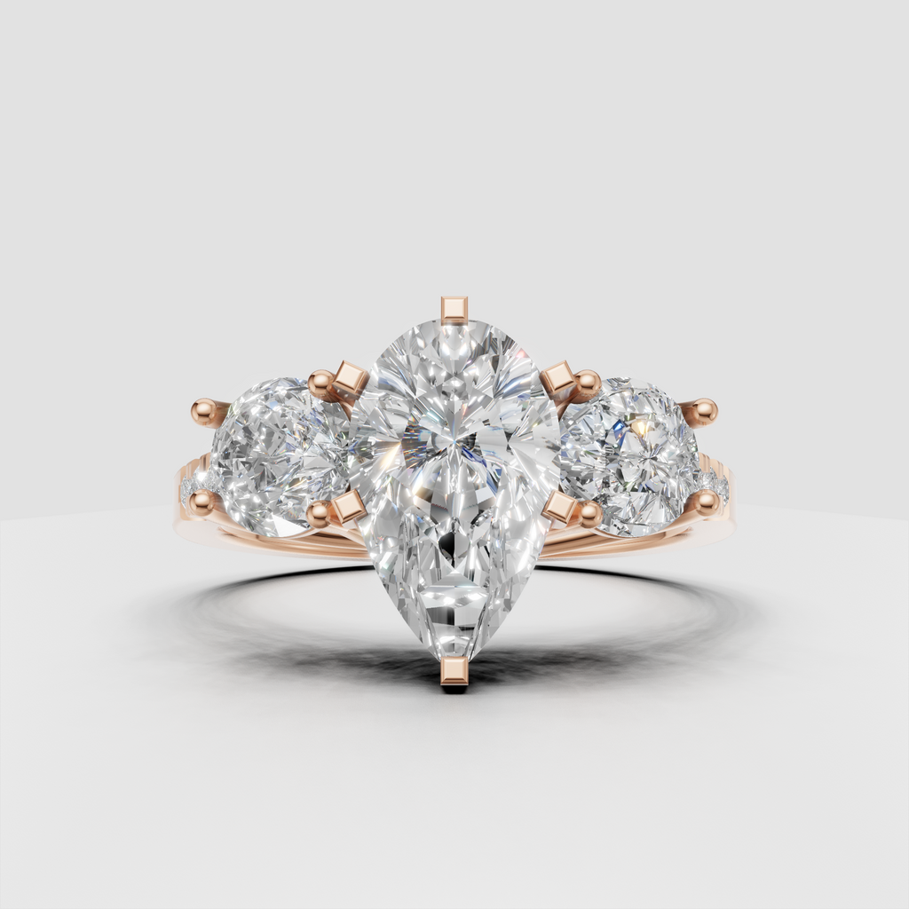 Luxury three stone diamond ring with pear shaped center stone