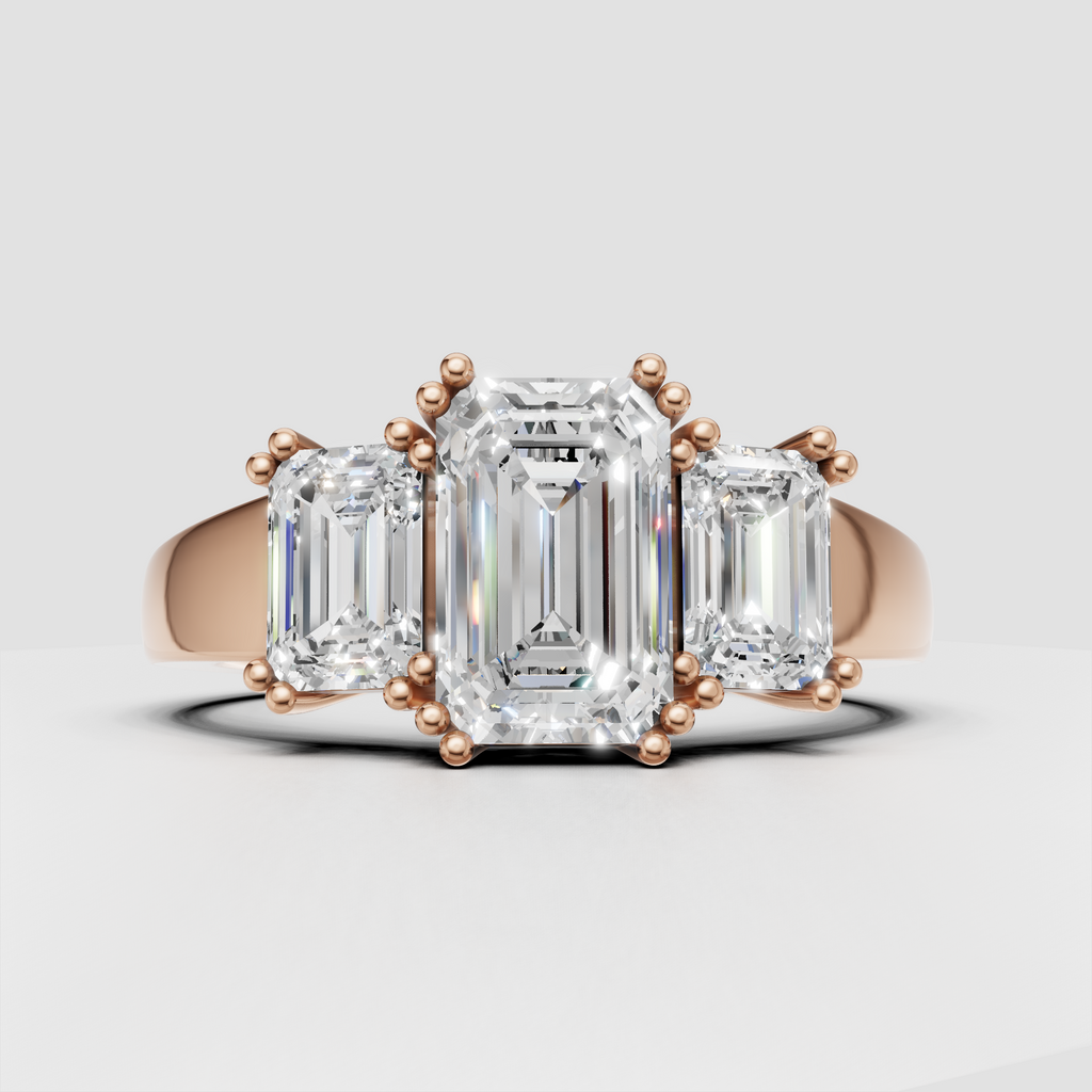 Three stone engagement ring featuring emerald cut gemstones