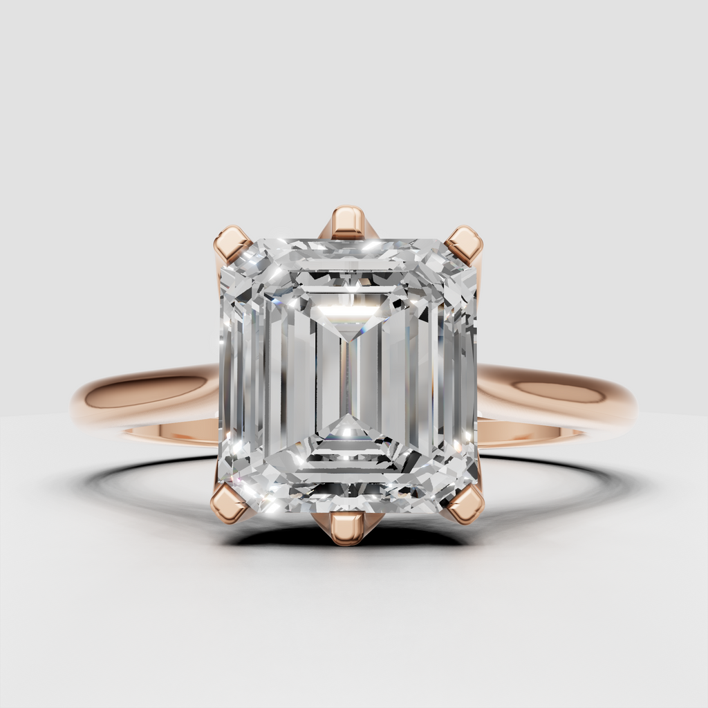 Rectangular emerald cut diamond engagement ring with yellow gold setting