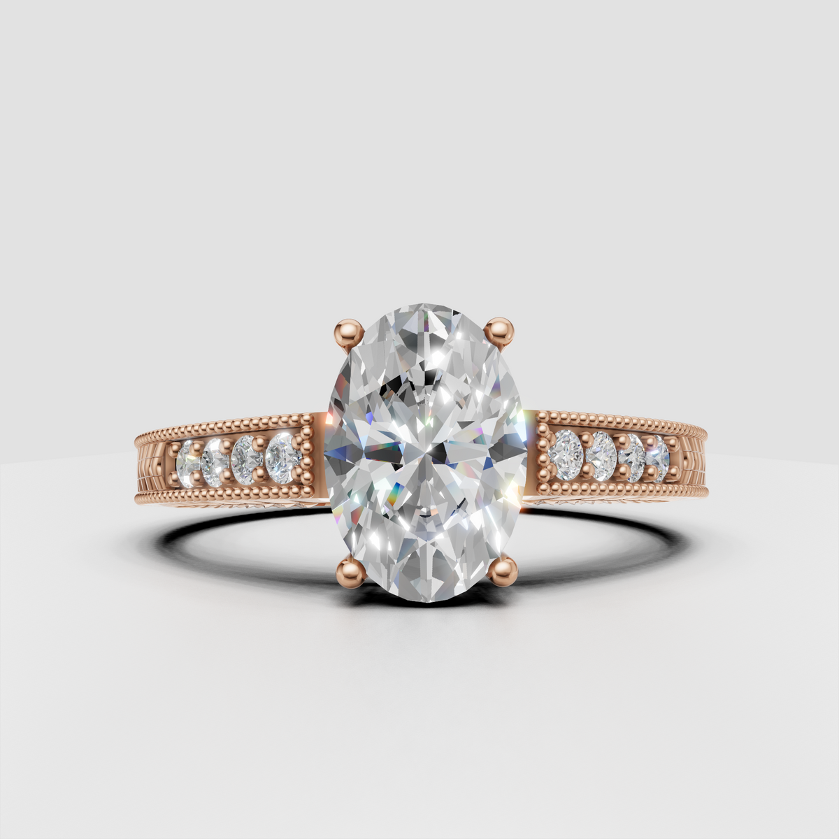 Oval diamond engagement ring with intricate floral-style engraved band