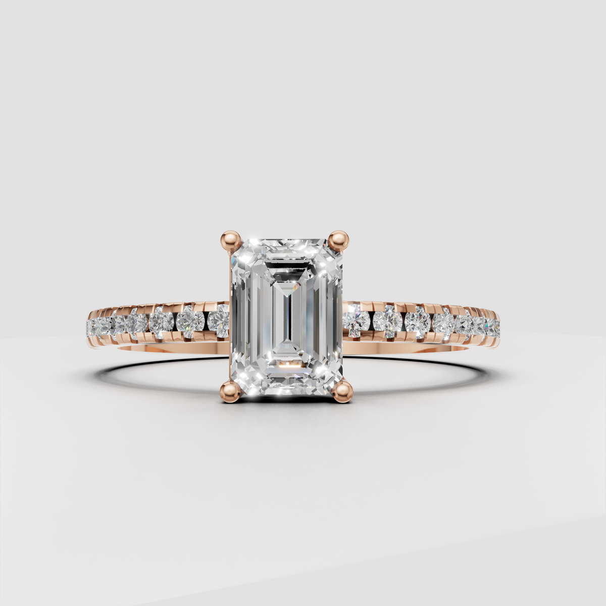 Emerald cut bridal ring with sparkling round stones along shoulders