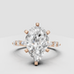 Pear cut diamond ring with marquise and round side stones