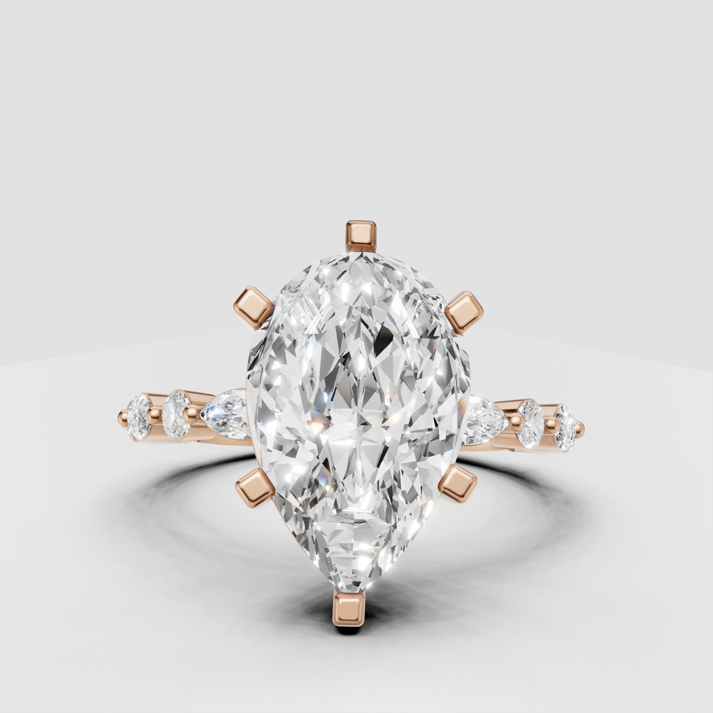 Pear cut diamond ring with marquise and round side stones