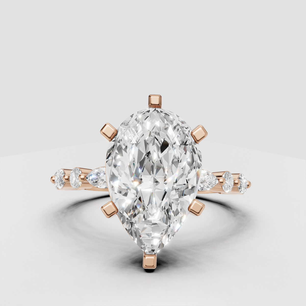Pear cut diamond ring with marquise and round side stones