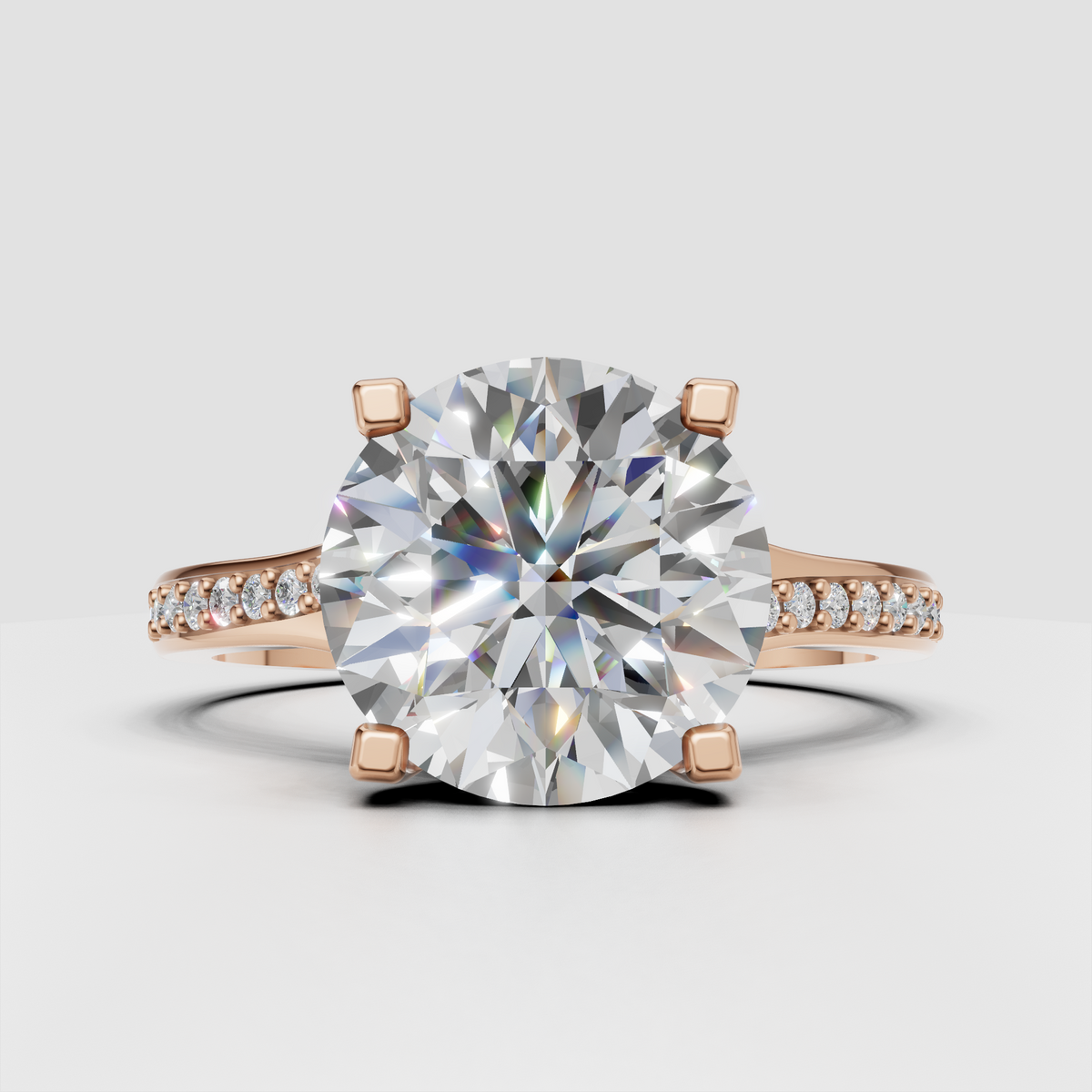 Four-prong round diamond ring with elegant cathedral shoulders