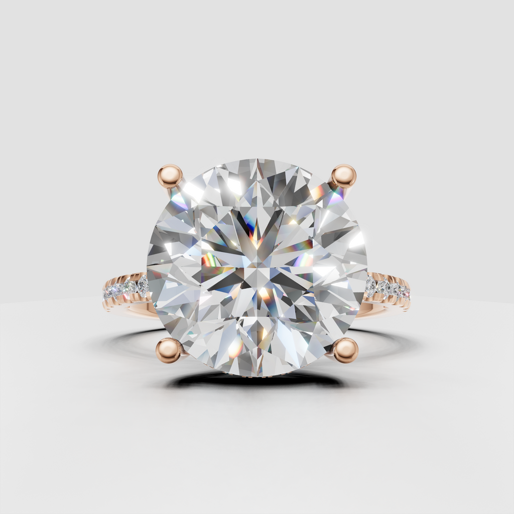 Round brilliant diamond ring viewed from the side with elevated four-prong setting and pavé band.