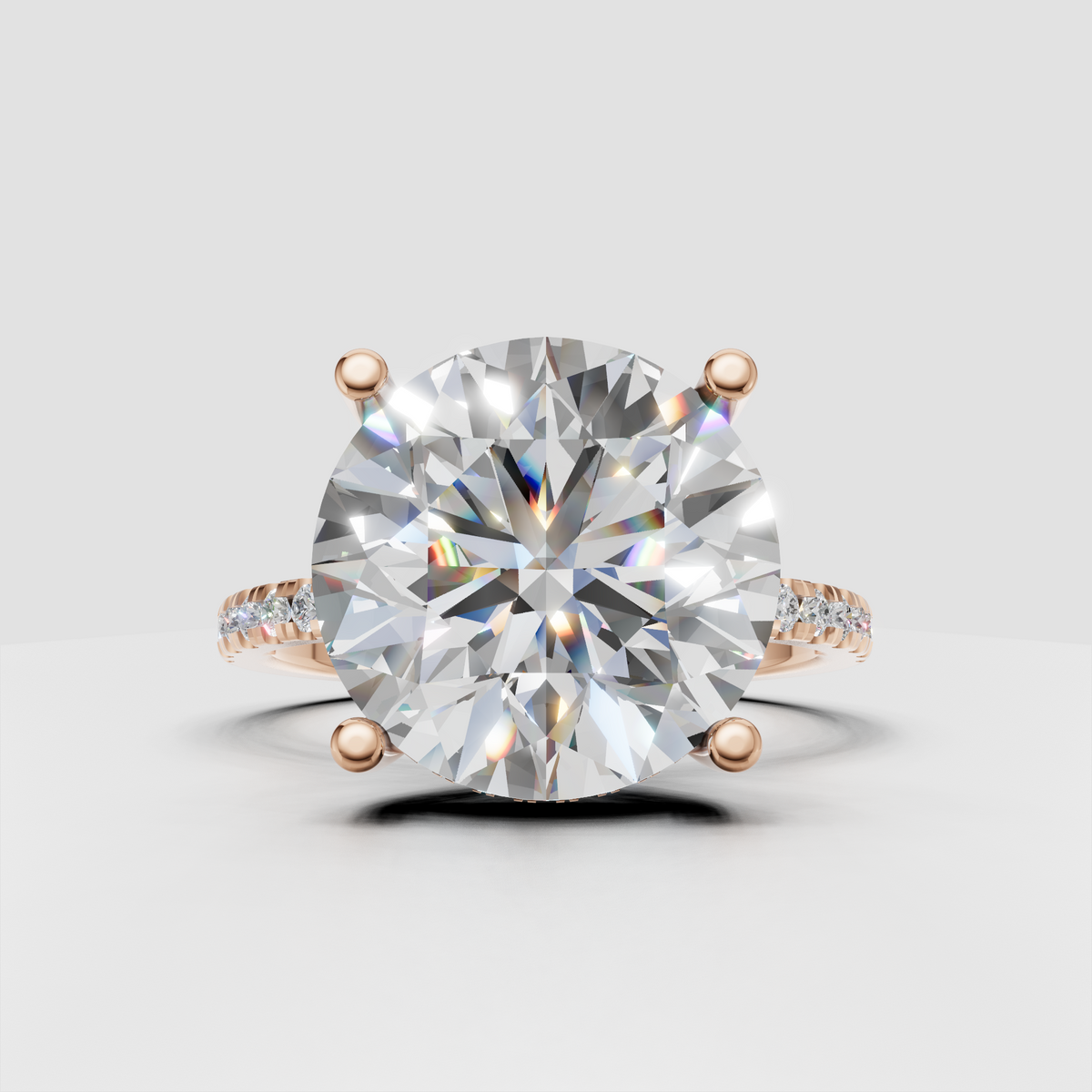 Round brilliant diamond ring viewed from the side with elevated four-prong setting and pavé band.