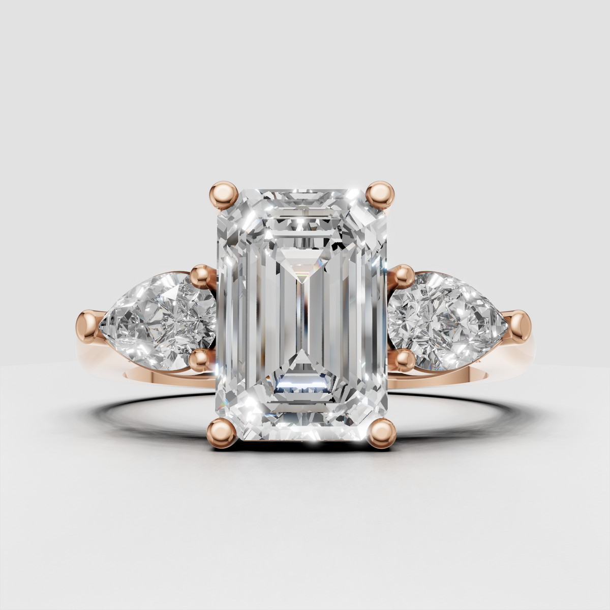 Emerald cut center diamond with pear-shaped side stones