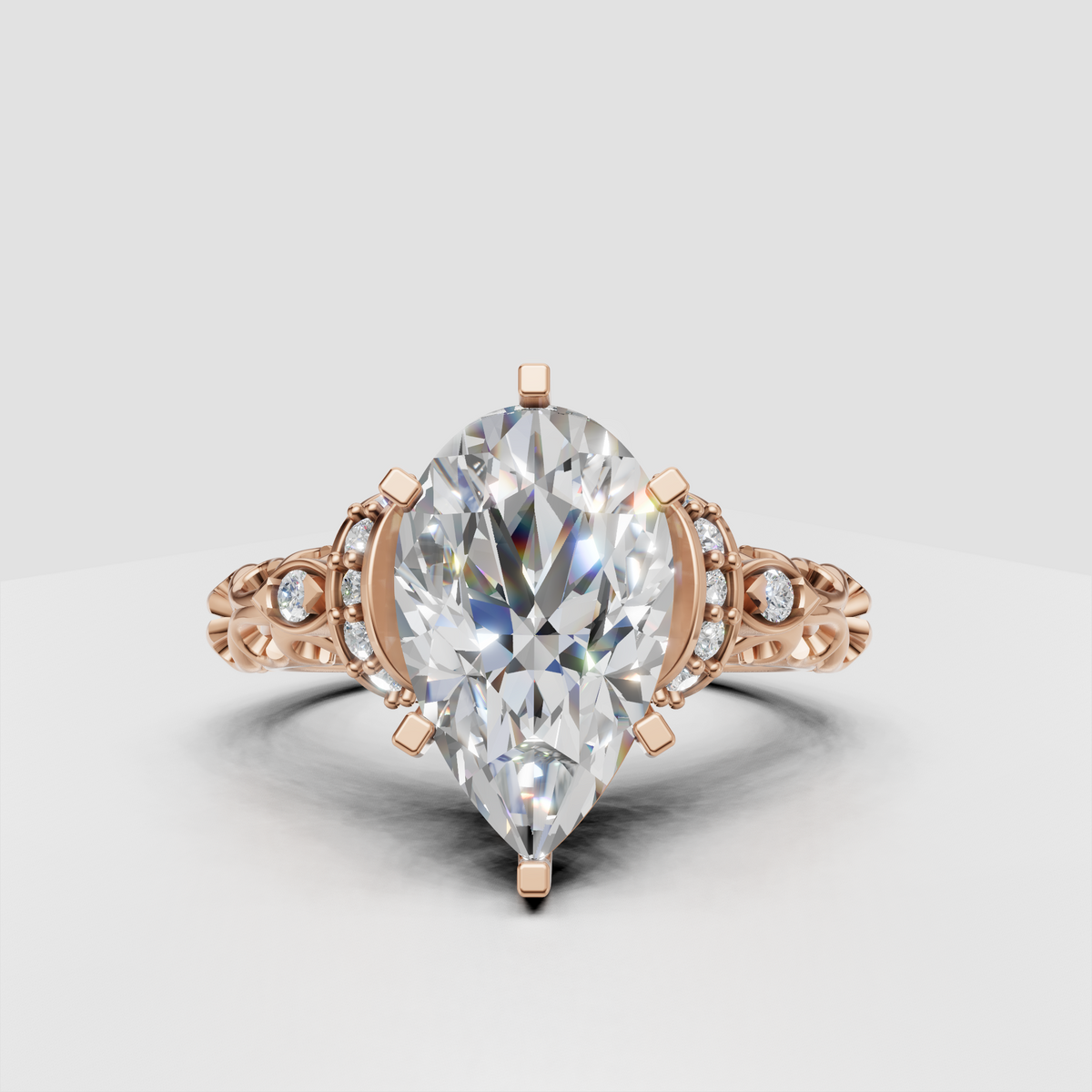 Yellow gold pear engagement ring with decorative halo and sculpted shoulders