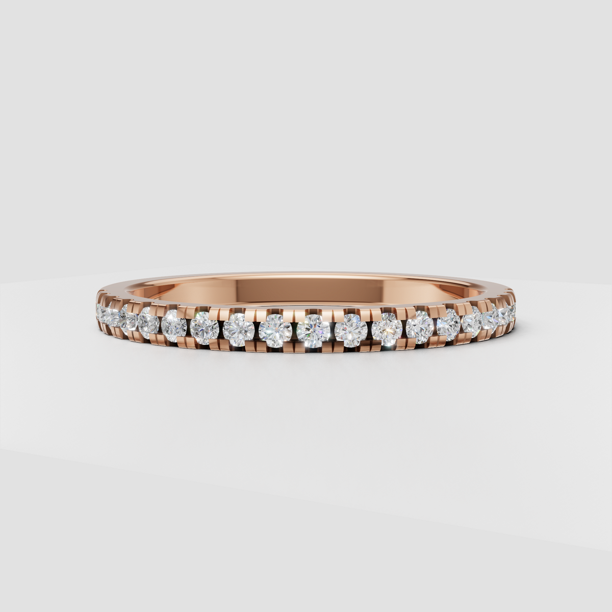 Close-up of round diamonds secured in a channel-style gold setting