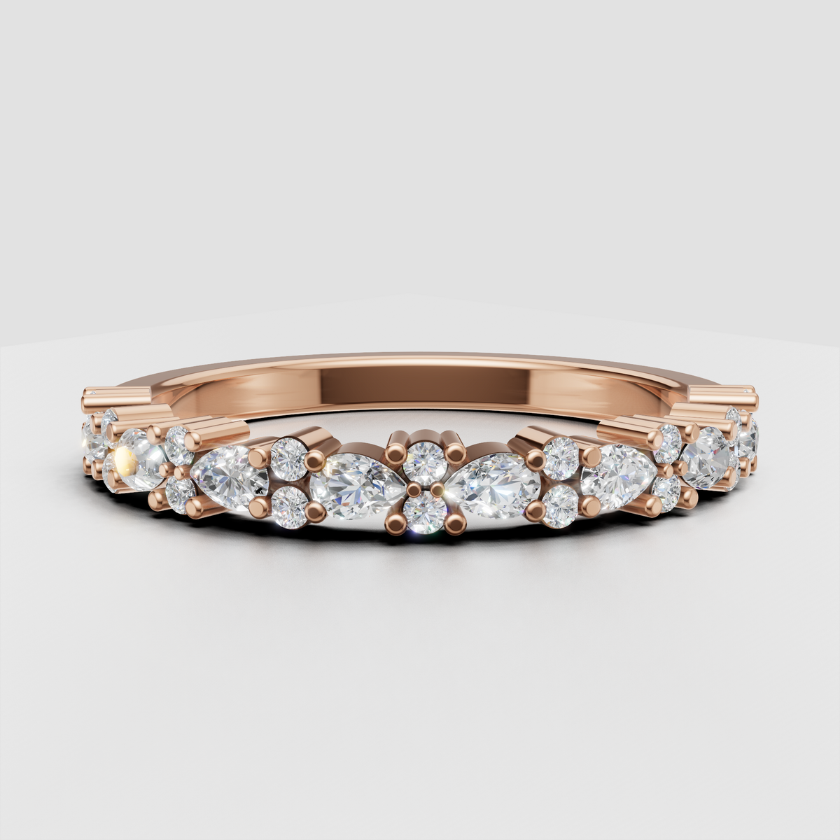 Angled view of round and marquise diamond half eternity wedding ring