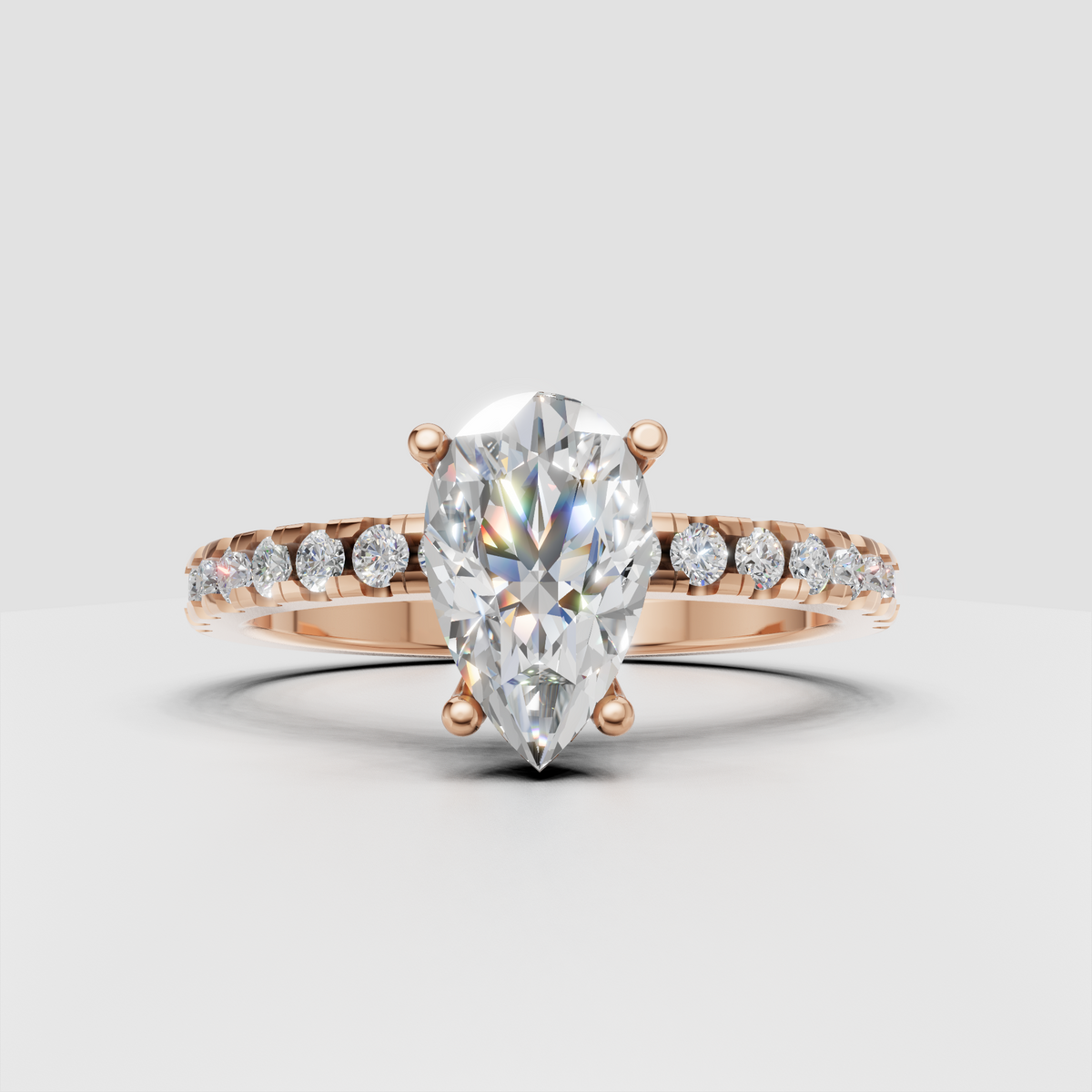 Pear center stone ring with sparkling diamond shoulder detailing