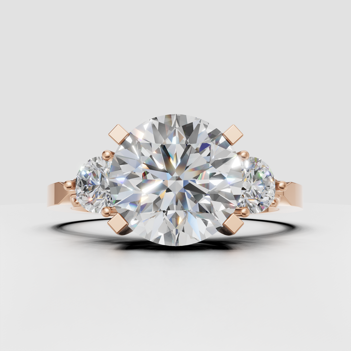 Round brilliant center diamond with matching side diamonds in yellow gold