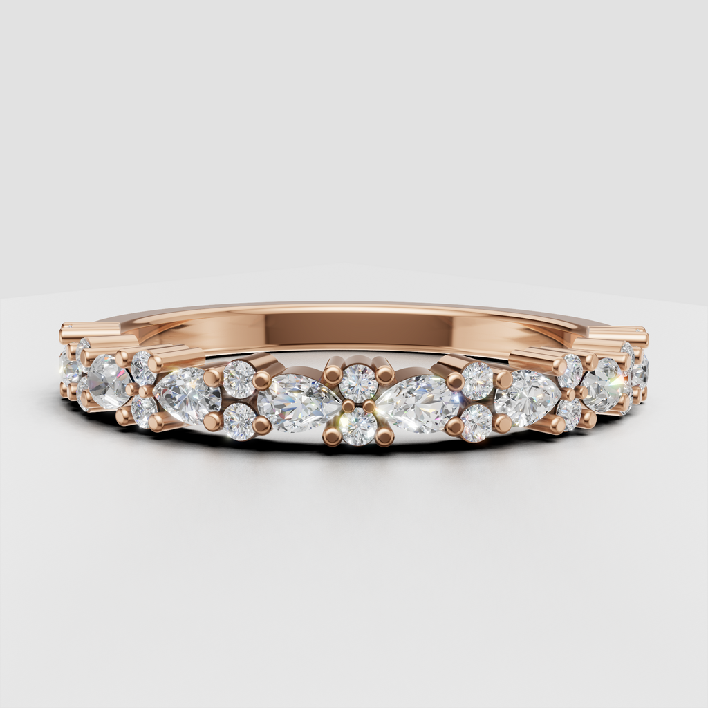 Close-up of round and pear diamond half eternity band with prong details