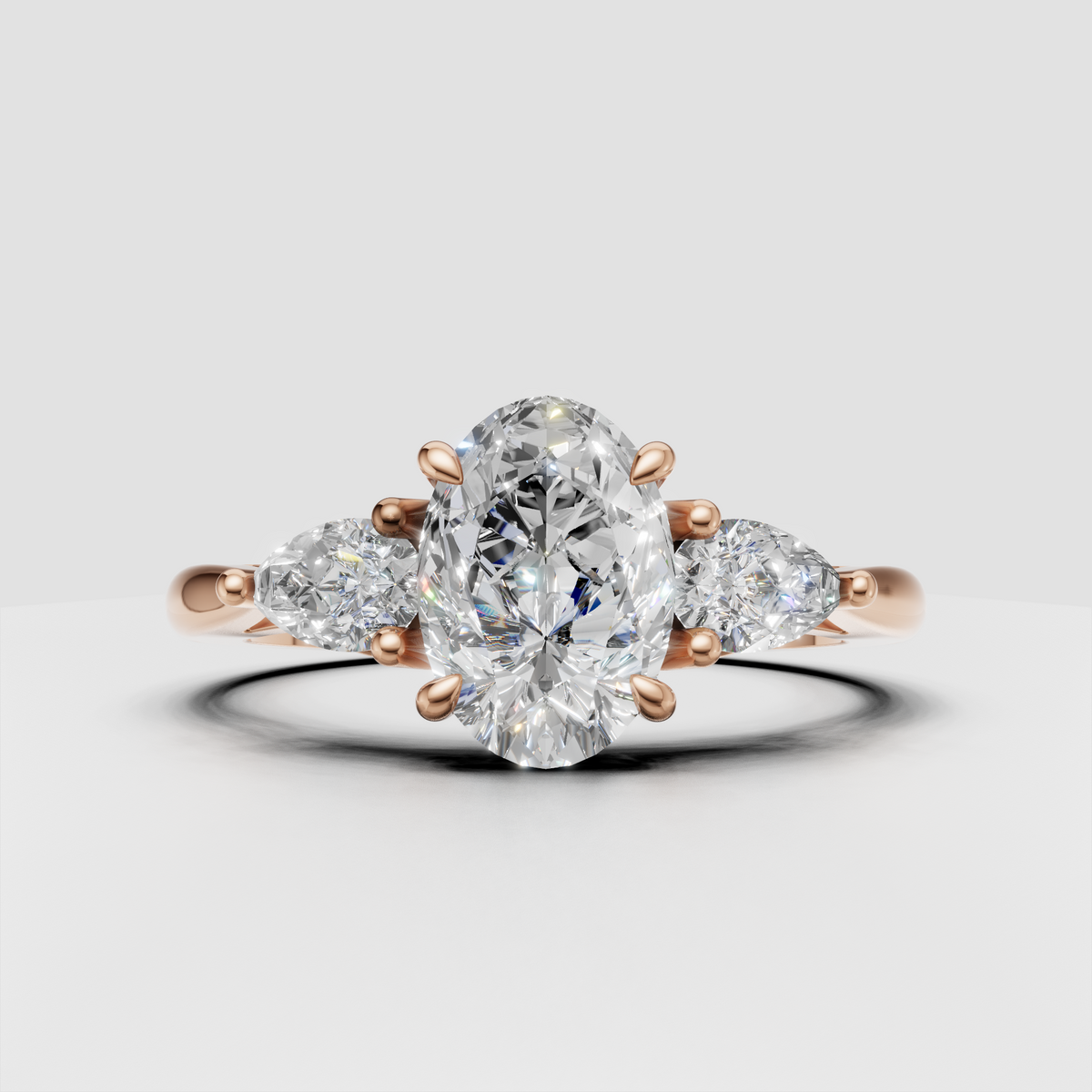Three-stone oval diamond ring with sculpted gold shoulders