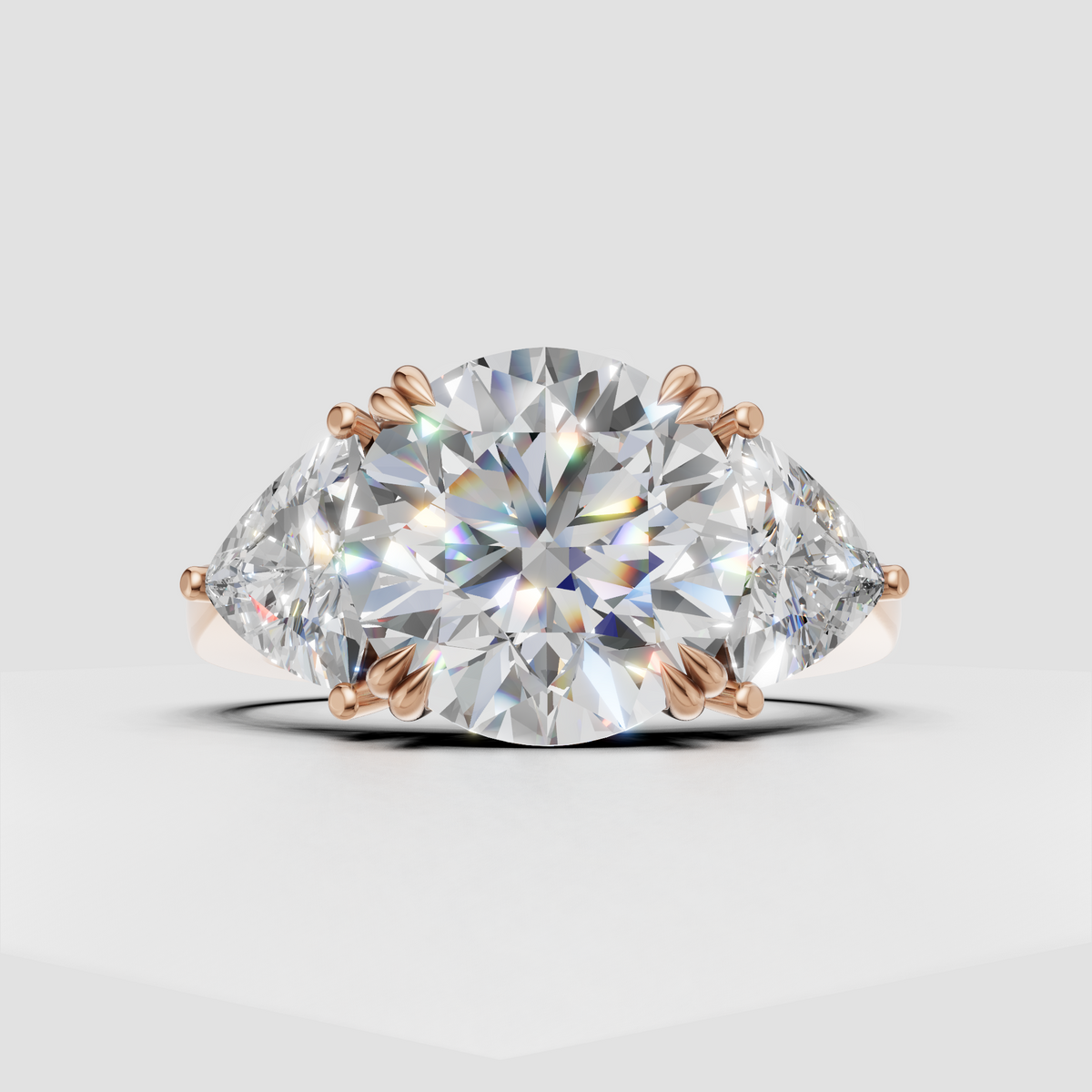 Round cut diamond ring with pear shaped side diamonds in a raised prong setting