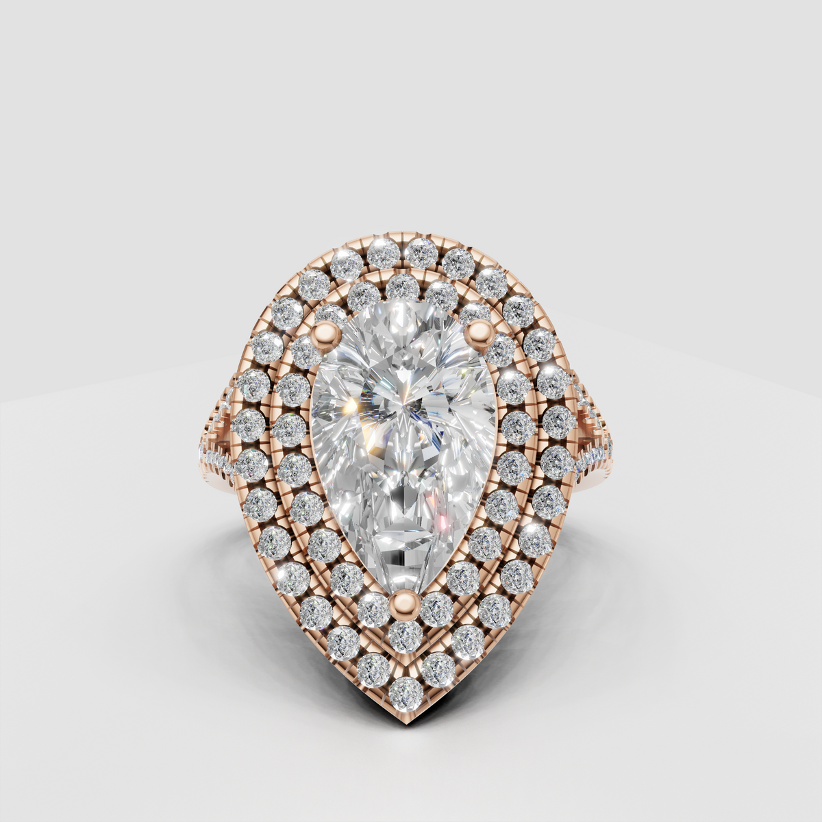 Pear shaped center stone surrounded by two rows of round accents