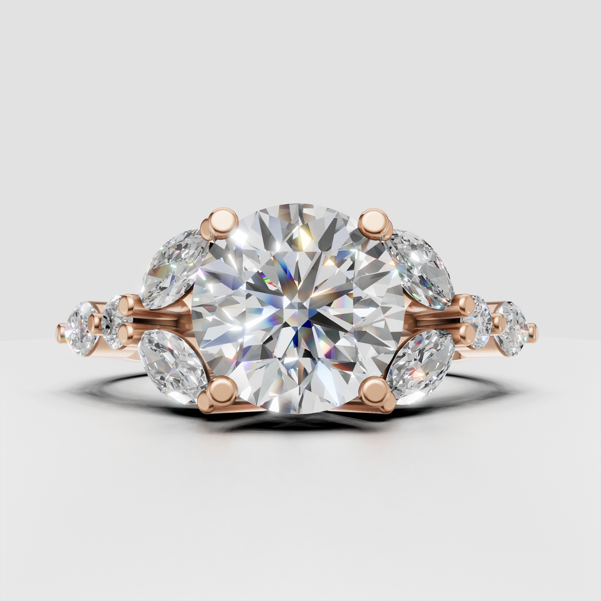 Nature inspired engagement ring with round center diamond and marquise cluster