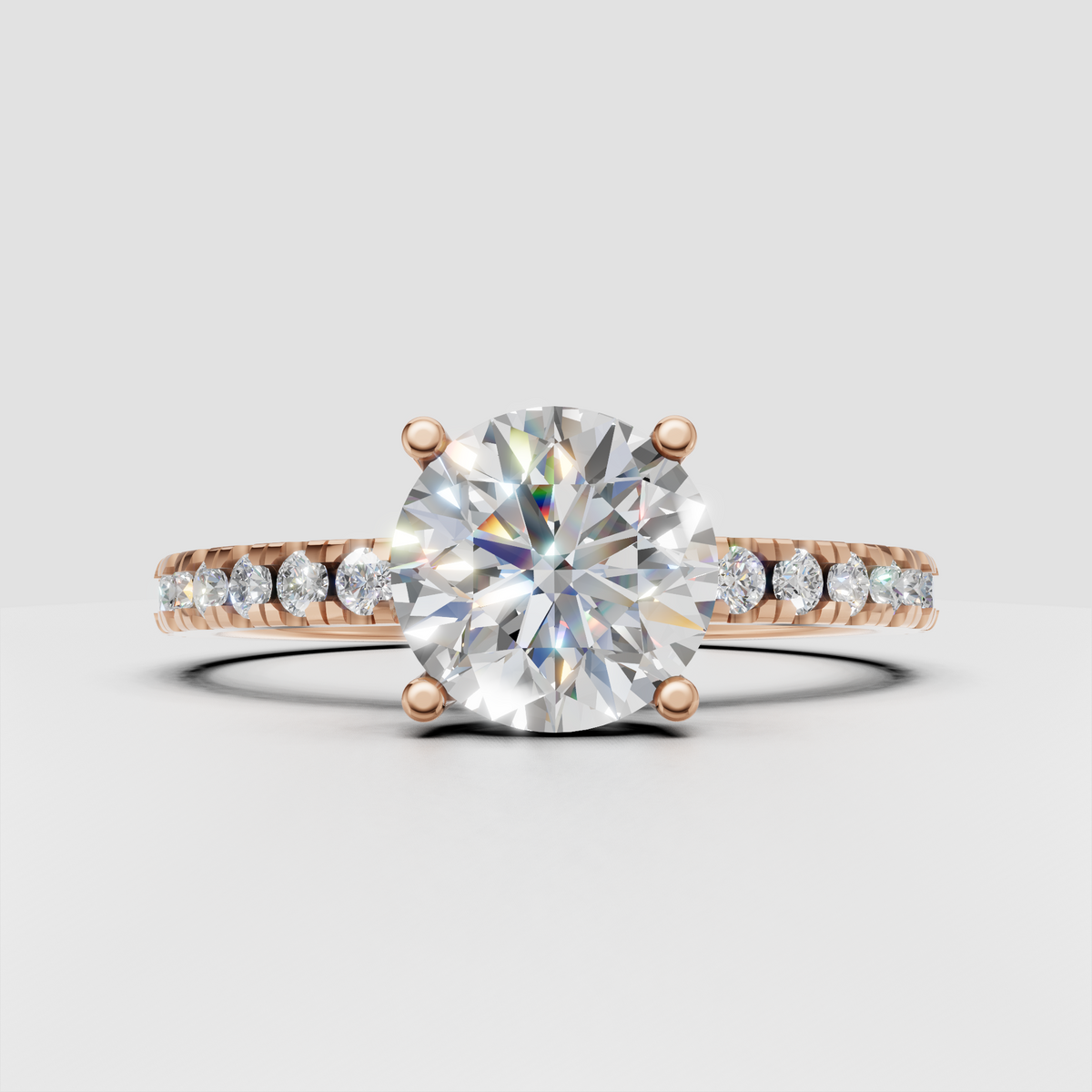 Four-prong round diamond solitaire ring with pavé shoulders