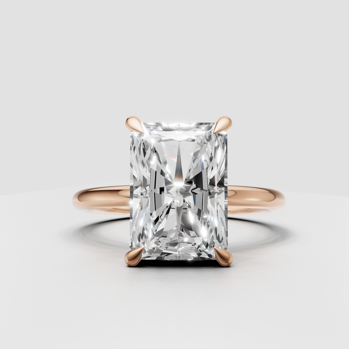 Polished yellow gold ring with elongated radiant cut center stone