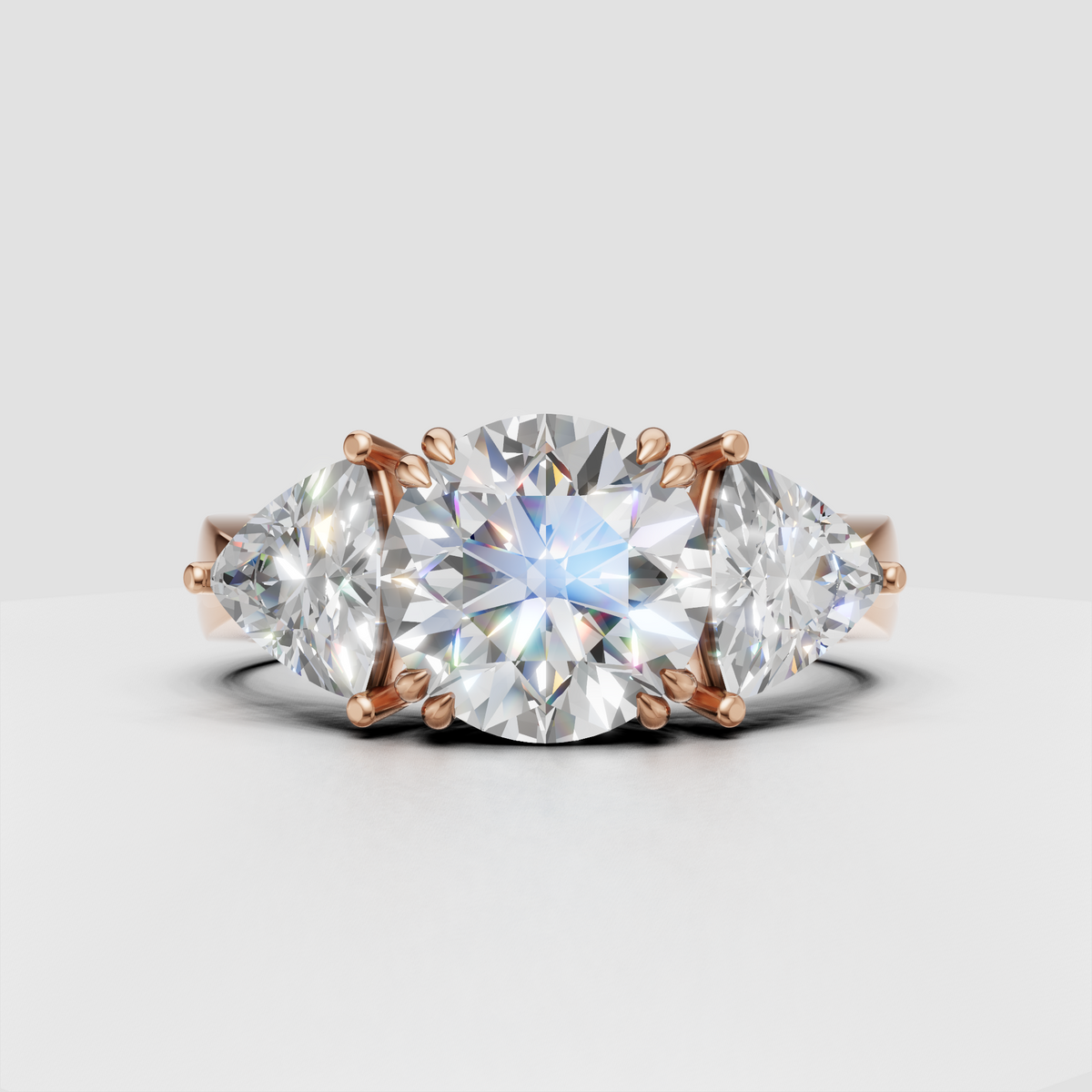 Luxury round diamond engagement ring with symmetrical Trillion side stones