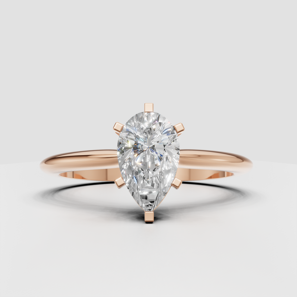 Close-up pear shaped diamond engagement ring with prongs