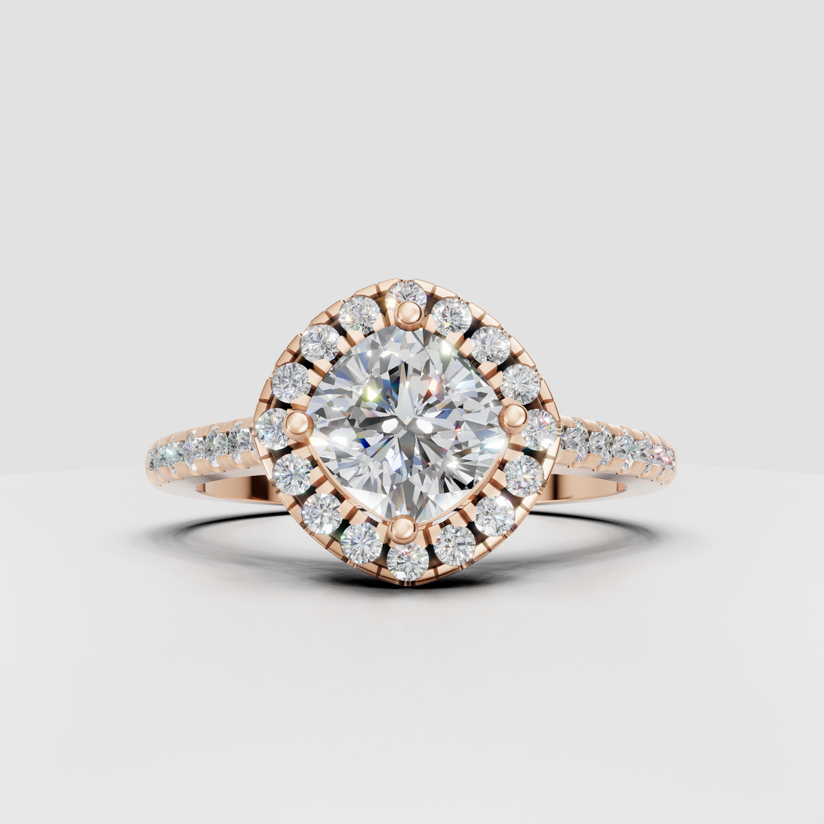 Yellow gold cushion halo ring with intricate open gallery beneath center stone