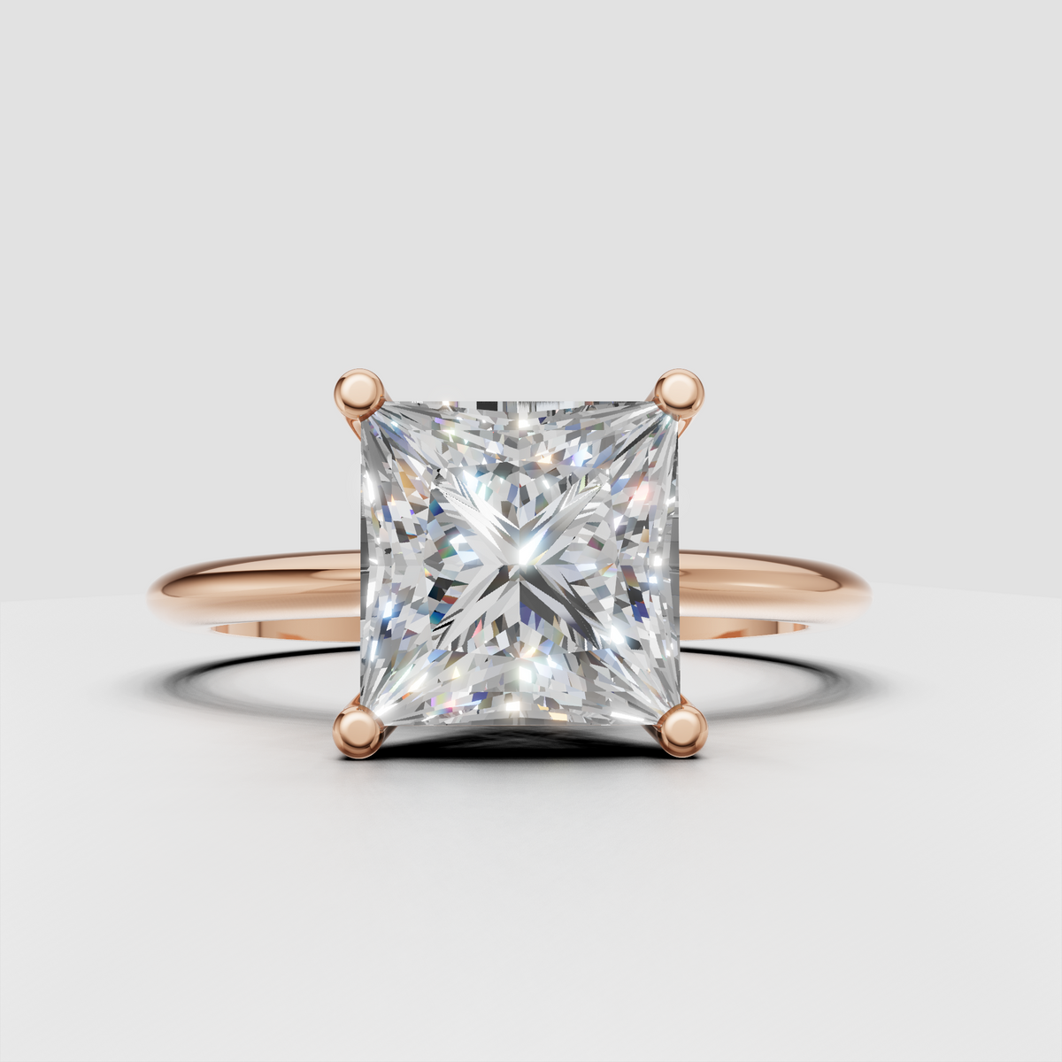 Yellow gold princess cut diamond solitaire ring with four prong center setting