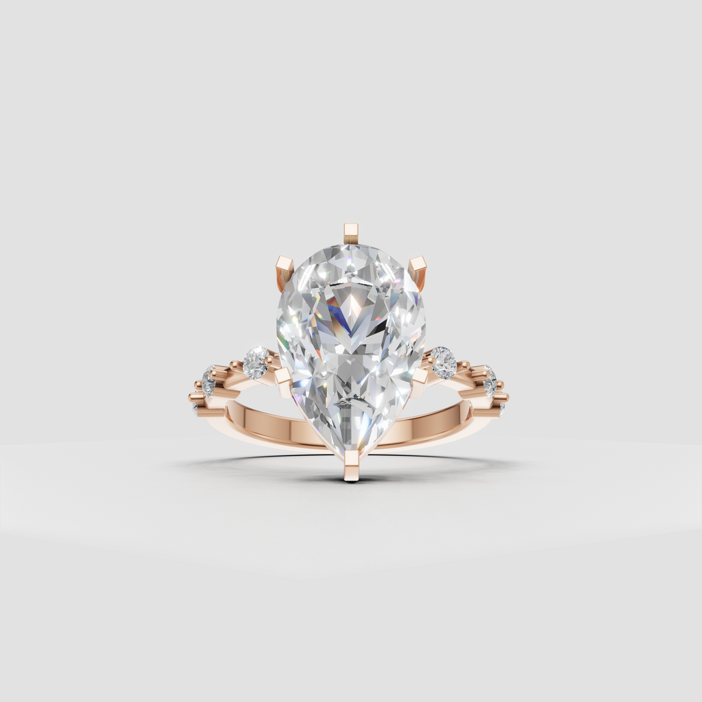 Pear diamond ring with round side stones on shoulders