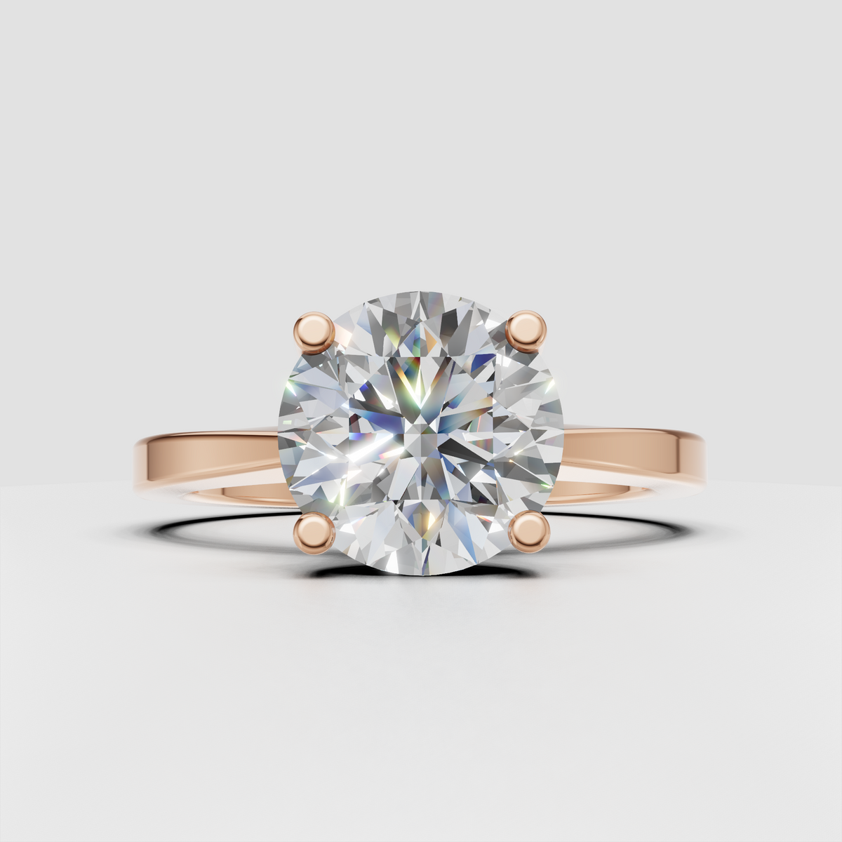 Round diamond engagement ring with smooth tapered gold band
