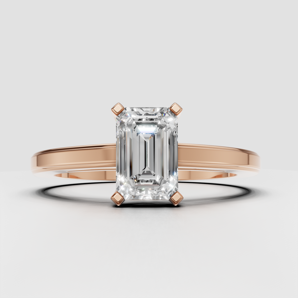 Emerald diamond ring featuring elongated step-cut canter stone
