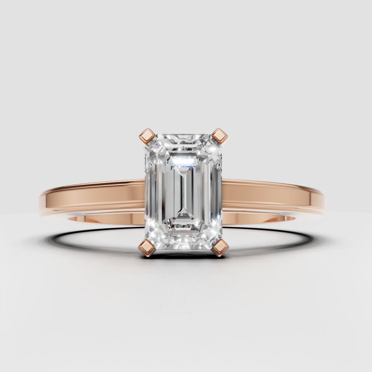Emerald diamond ring featuring elongated step-cut canter stone