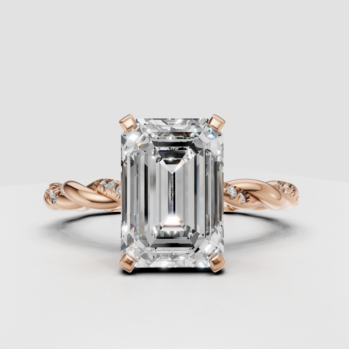 Twisted yellow gold diamond engagement ring with emerald cut center stone