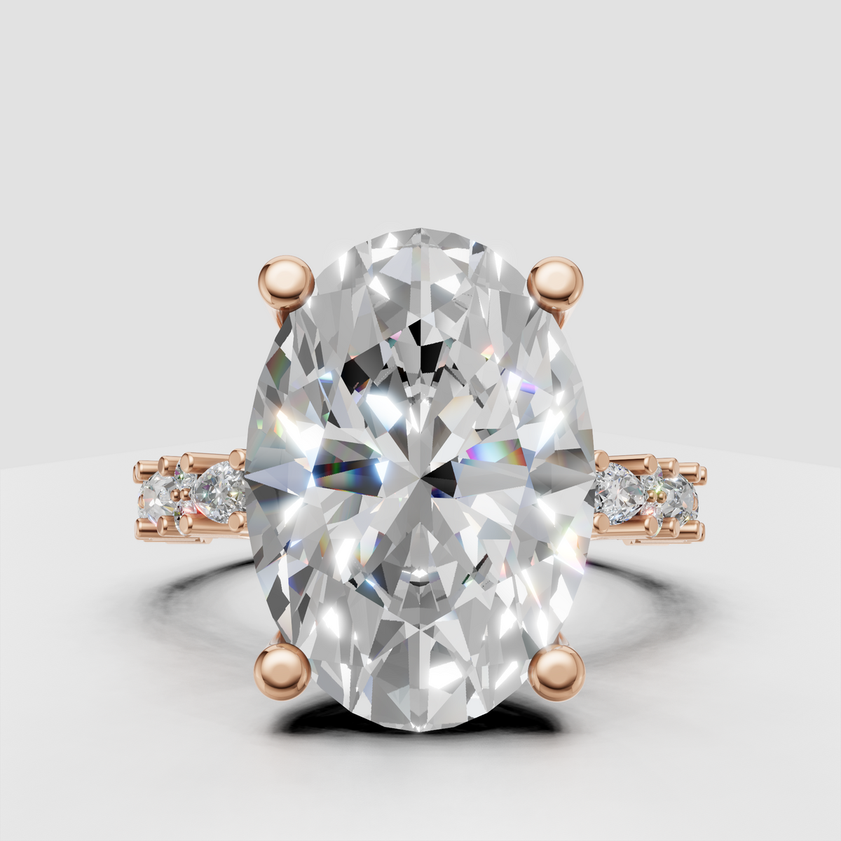 Four-prong oval diamond engagement ring with diamond-studded shoulders