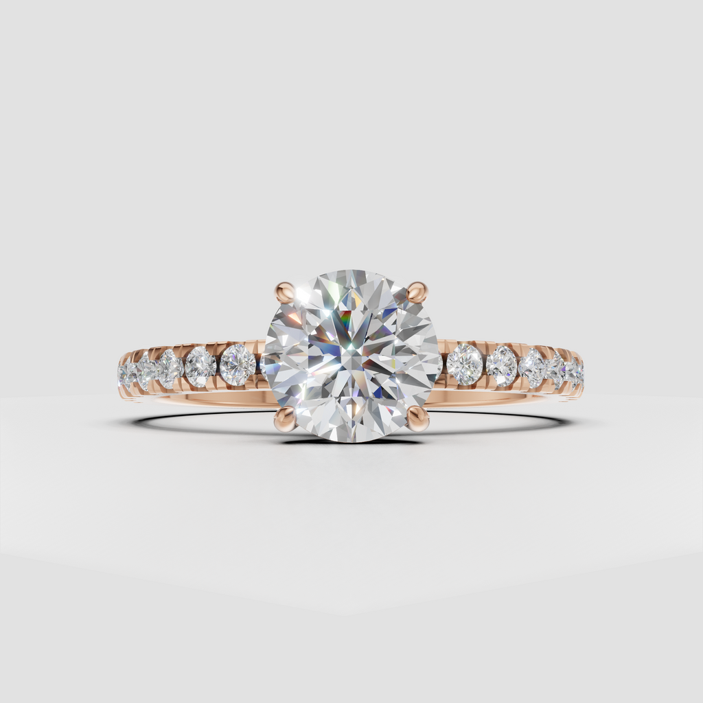 Four-prong round diamond ring with delicate gold pavé shoulders