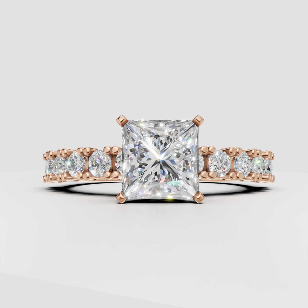 Yellow gold princess engagement ring with round pavé diamond accents