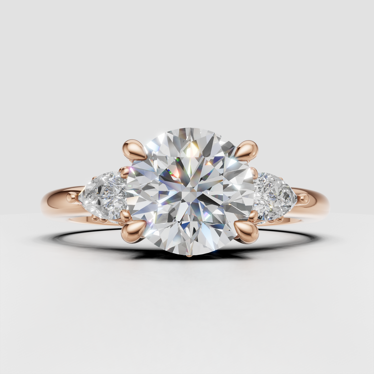 Three stone round diamond ring with intricate leaf-inspired detailing