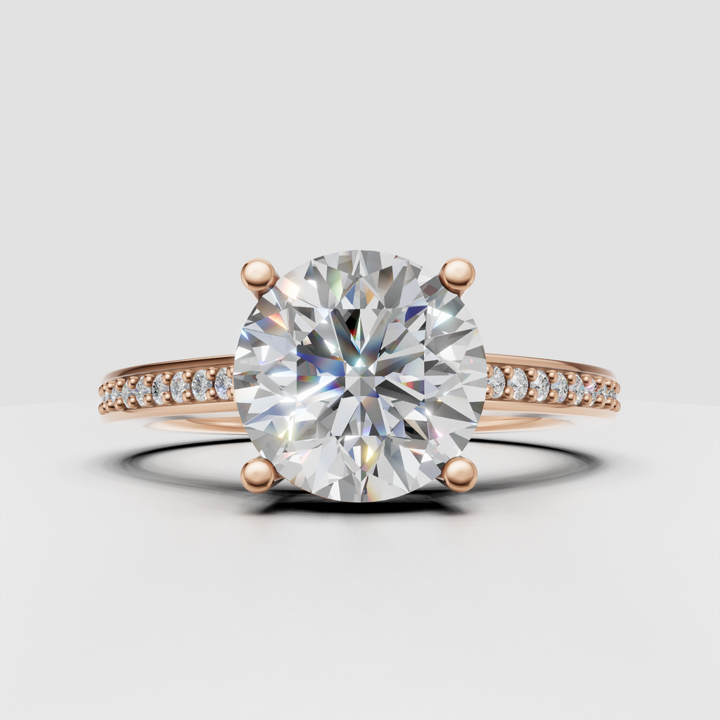 Round diamond bridal ring with slim pavé band and four-prong center setting.