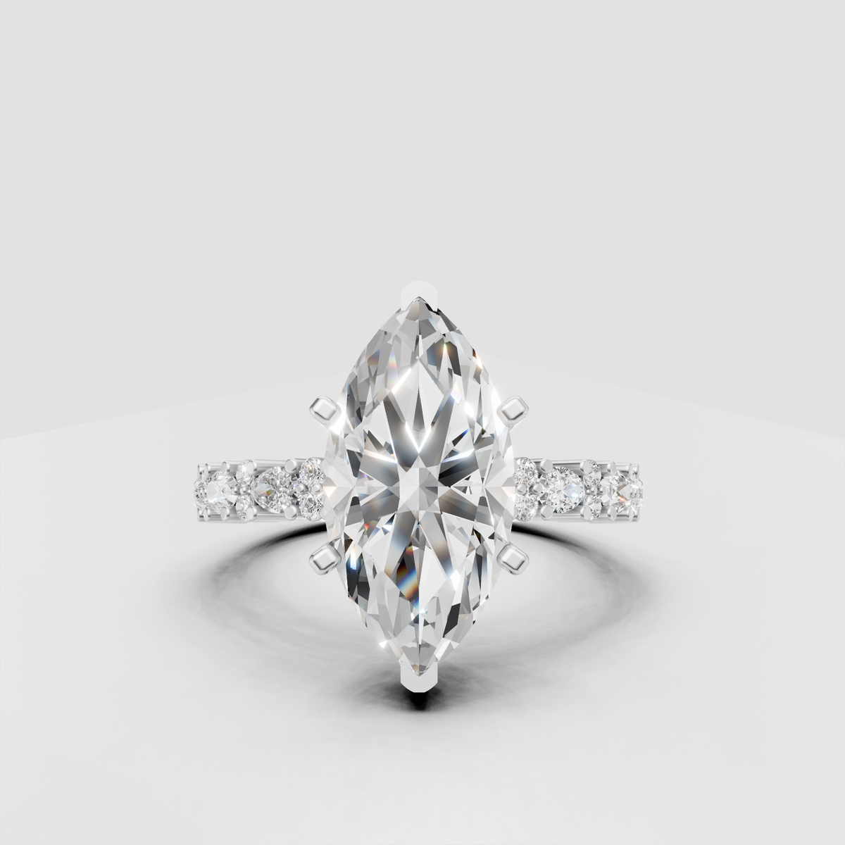 Marquise diamond ring featuring detailed pavé yellow gold shoulders