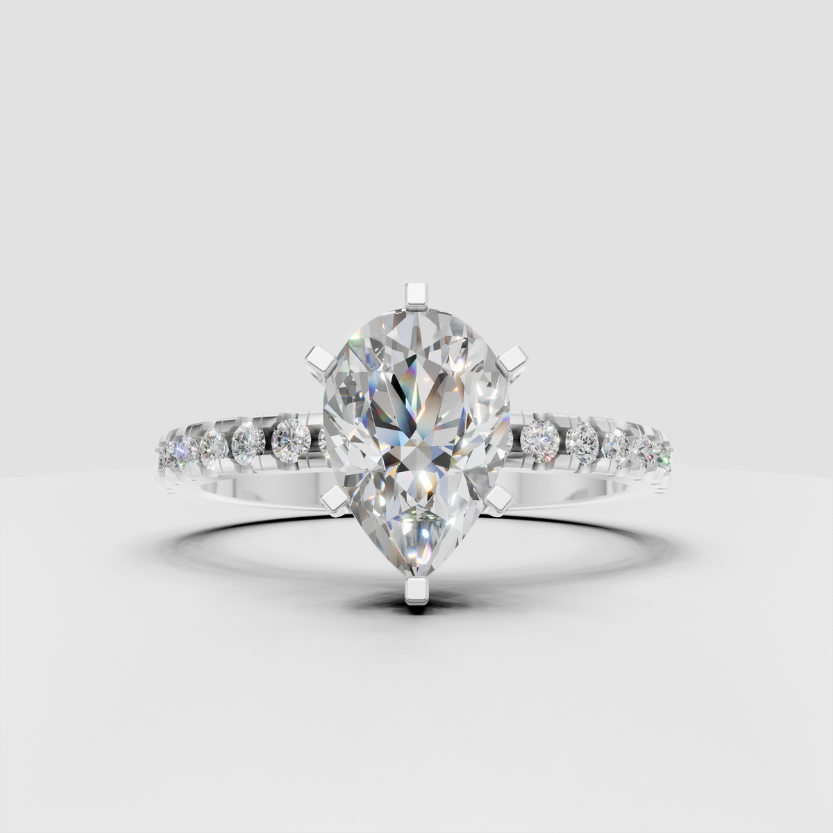 Pear shaped solitaire engagement ring with diamond accents