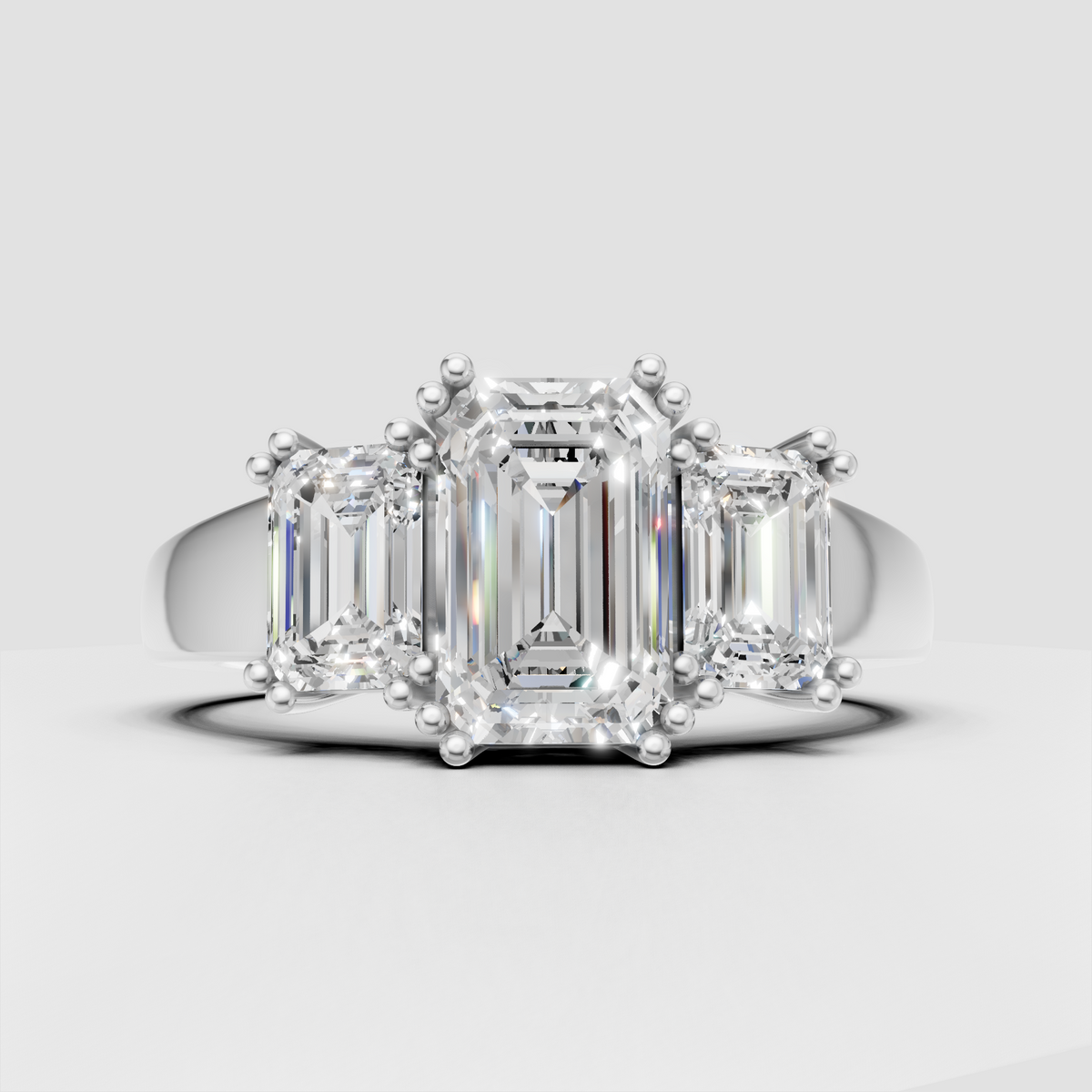 Emerald cut Diamond three stone ring with prong setting