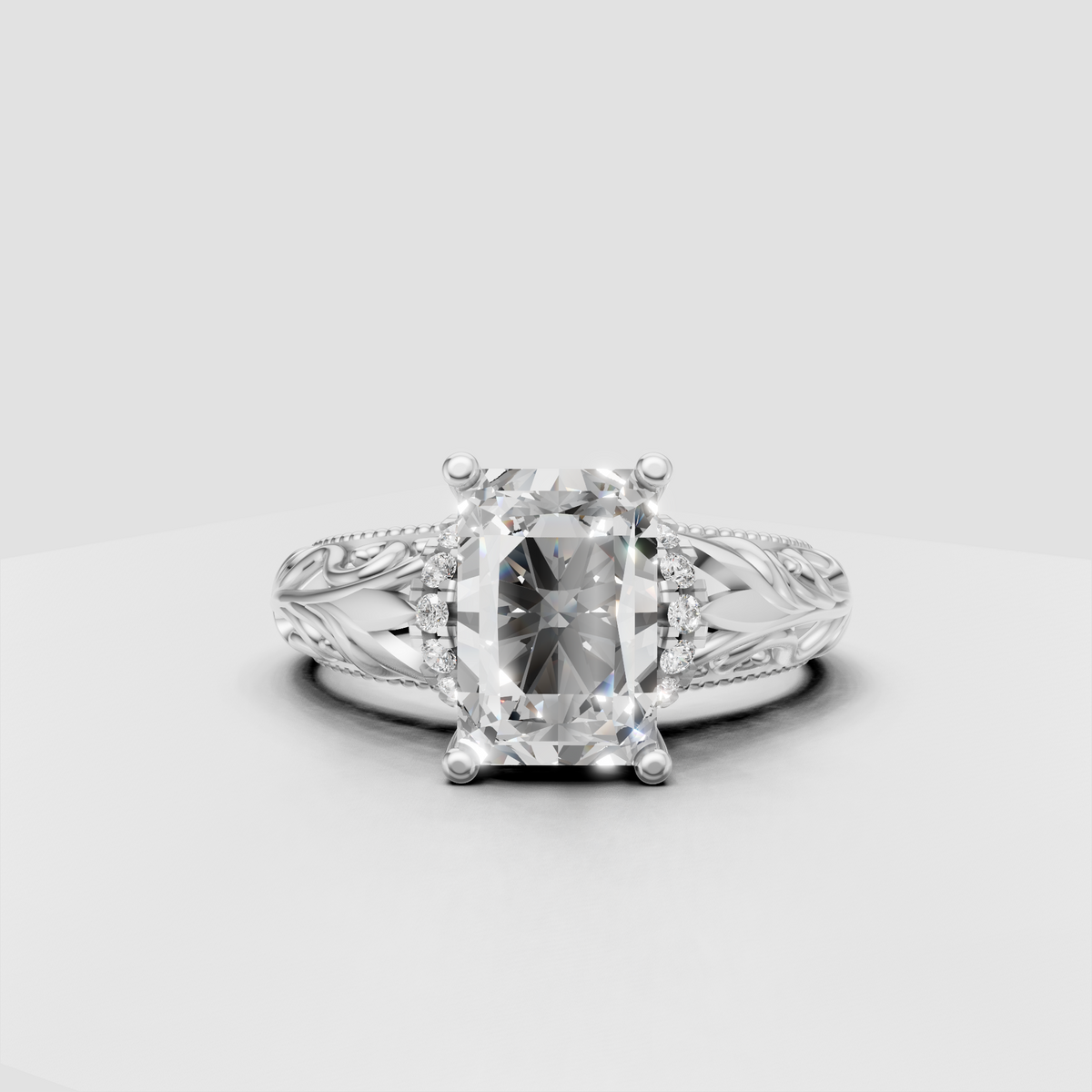 Radiant diamond engagement ring with openwork filigree and sparkling shoulder stones